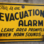 Sign showing the text "This is an evacuation alarm. Leave area promptly when the horn sounds.".